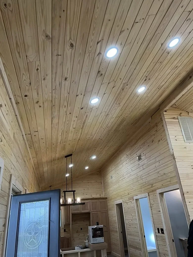 Diagonal knotty pine ceiling with recessed LED lights and matching wood wall paneling
