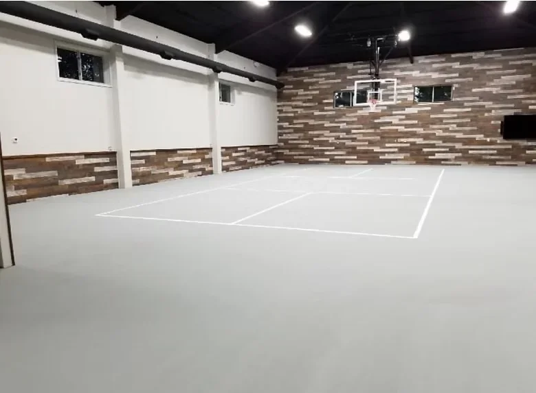 Polished concrete sports court floor with white court markings in indoor facility